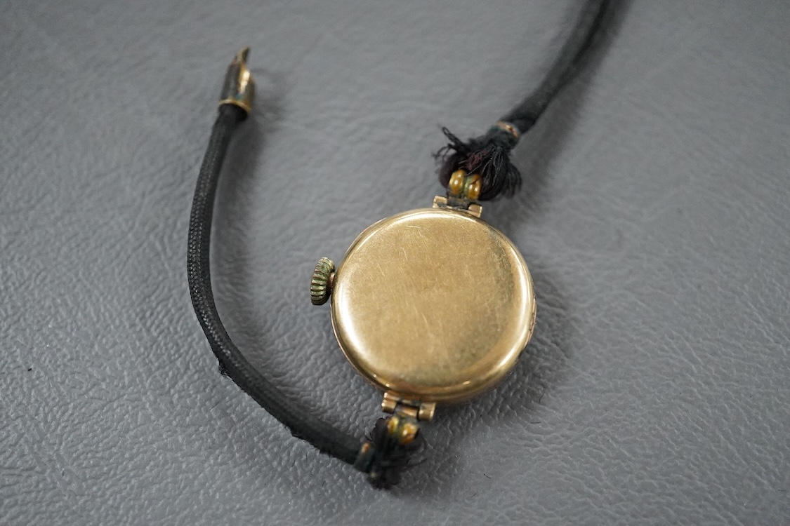 A lady's 1920's 9ct gold manual wind wrist watch, sunburst Arabic dial, case diameter 23mm, on and associated fabric strap.
